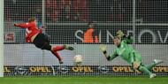 Leverkusen's striker Stefan Kiessling (L) scores past Schalke's goalkeeper Lars Unnerstall